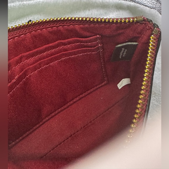Coach Corner Zip Wristlet in the color 1941 Red with Horse and Carriage print.